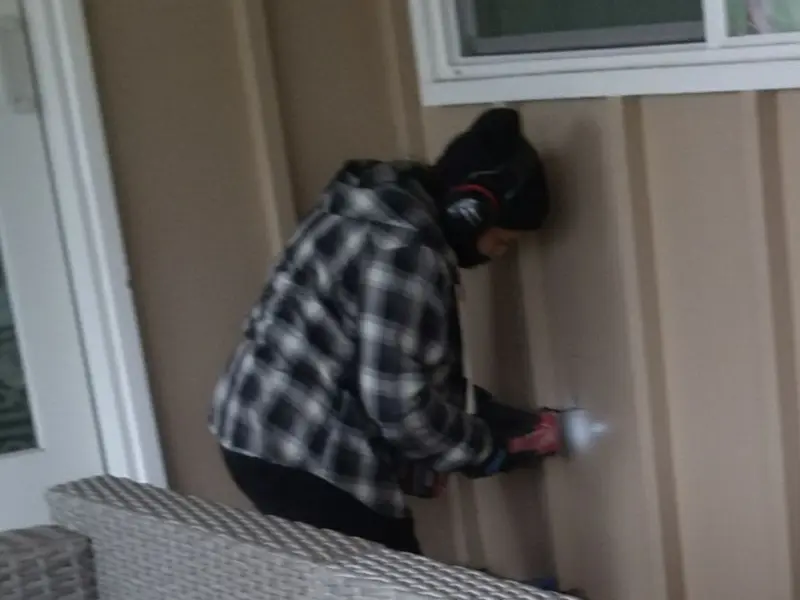 Professional electrician installing an exterior outlet in Delran