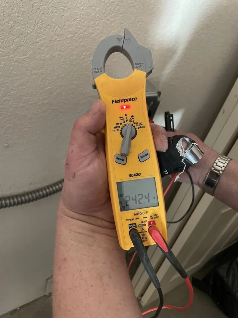 Voltage testing with clamp meter during Ceiling Fan Installation in Delran